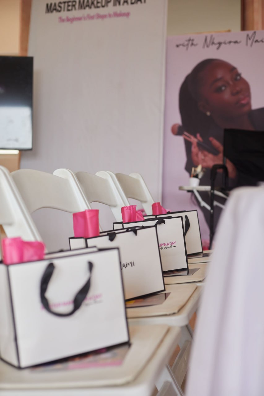 Personalised gift bags with hot pink tissue lined along the chairs at Edition 1