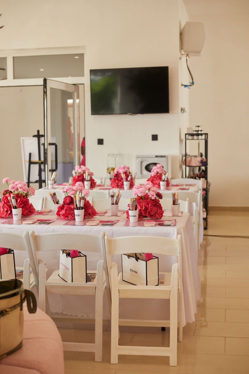 Pink and red floral centrepieces running down the Edition 1 makeup table