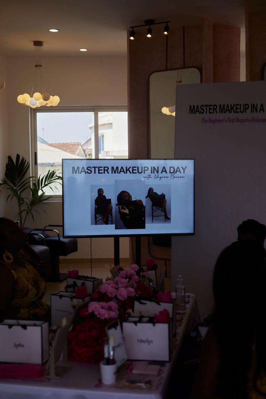The Master Makeup in a Day screen with gift bags and pink florals in the foreground